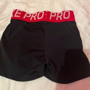 Black Nike pros with red band